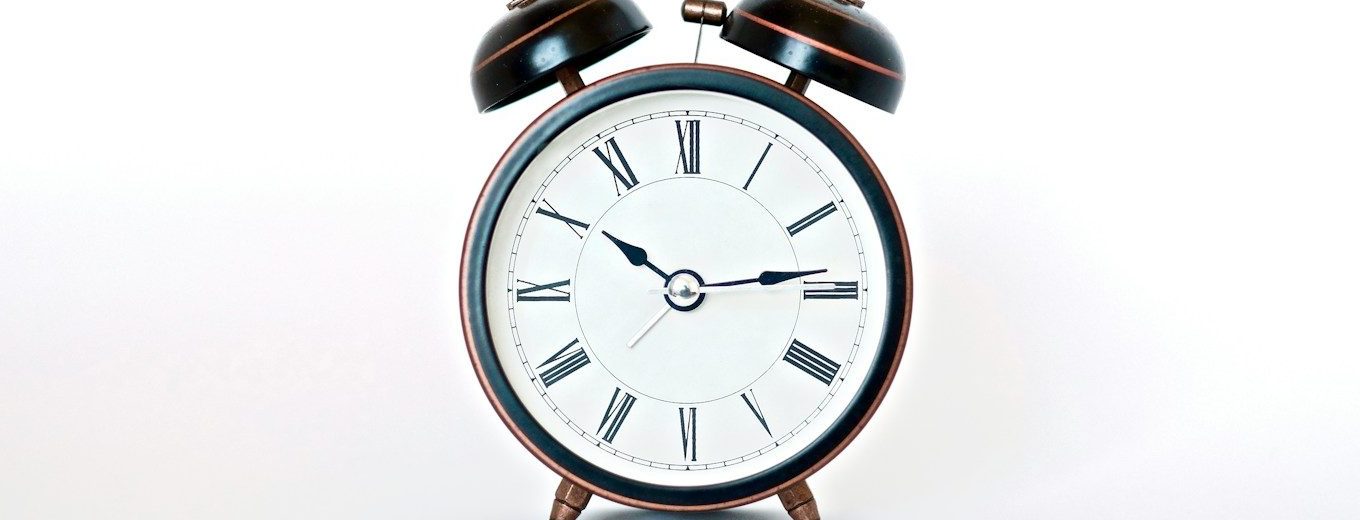 round black and white analog alarm clock