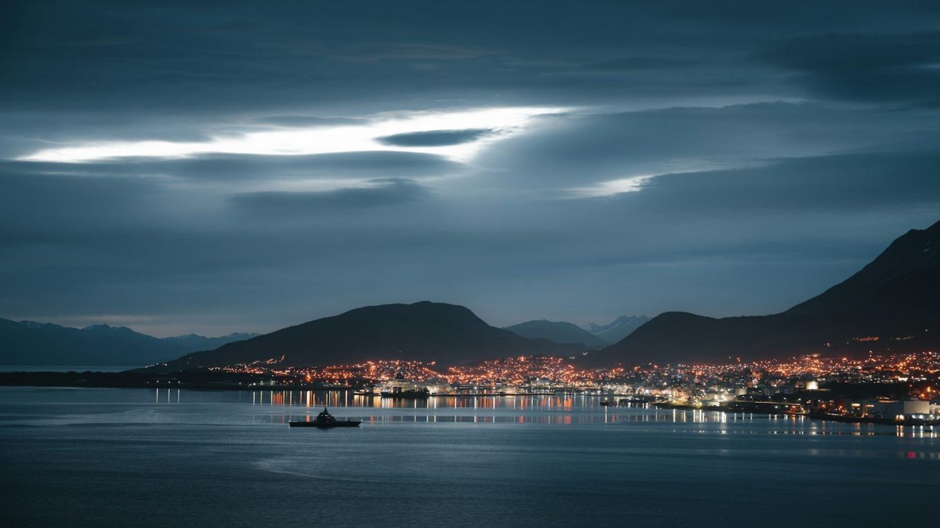 A view of a city at night from across the water