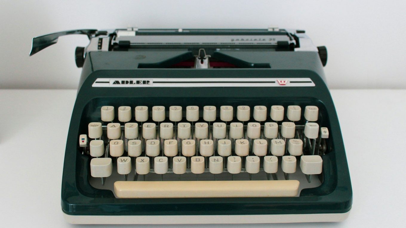 black and white typewriter on white table
